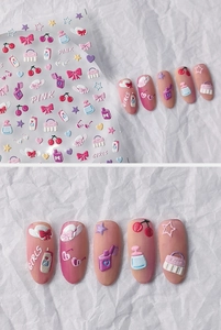 Macro shot of 5D embossed pink nail stickers with bow, cherry, and perfume bottle patterns