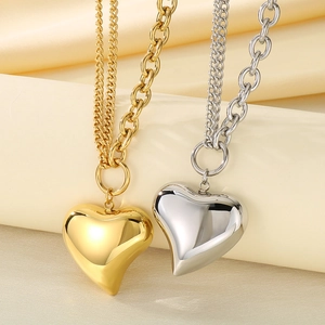 Gold and silver heart pendant necklaces on silk, featuring layered O-chain design