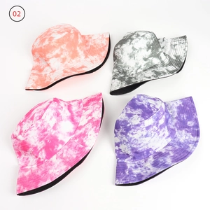 Flat lay of colorful tie-dye bucket hats in coral, gray, pink, and lilac with fine stitching