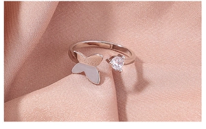 Detailed macro view of silver butterfly ring with cubic zirconia on purple silk