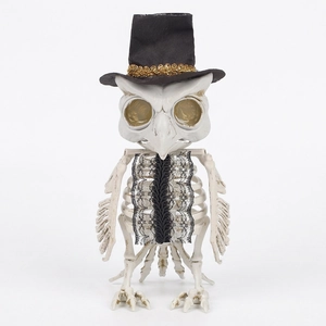 Realistic owl skeleton Halloween decor with black top hat and lace bow on white background
