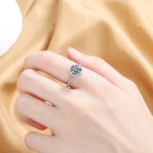 Detailed view of an elegant halo ring with round zircon stones on shimmering gold fabric