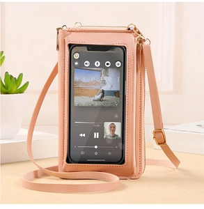 Detailed view of pink leather crossbody bag featuring a transparent touch-screen phone window