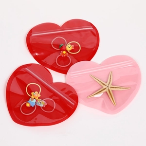 Macro detail of red and pink heart-shaped zip lock plastic bags for jewelry packaging