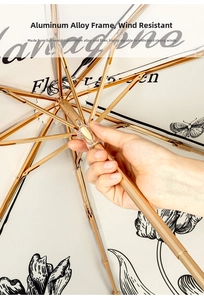 Detail of vintage tulip umbrella with sturdy aluminum ribs and elegant gold frame
