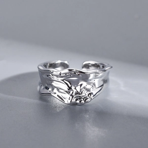 Macro shot of silver ring featuring irregular lava texture and shimmering zircon detail