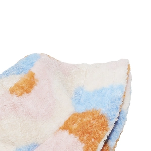 Macro detail of colorful patchwork plush bucket hat with soft faux lambswool texture