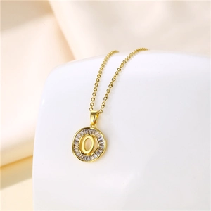 Close-up of 18K gold letter O necklace pendant with sparkling cubic zirconia inlay