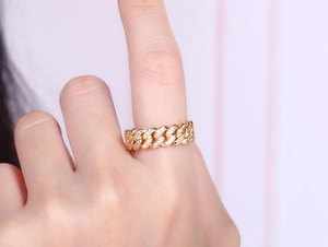 Macro shot of gold-plated 8mm Cuban link ring with full zircon stones on a male hand