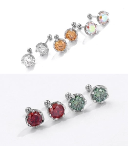 Macro detail of various zircon stud earrings in multiple colors with screw-back closures
