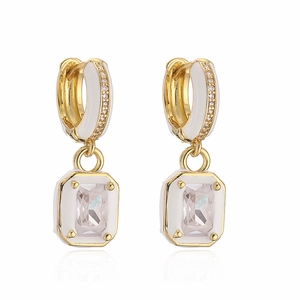 Detail of square gold earrings with white enamel and rectangle cubic zirconia stones