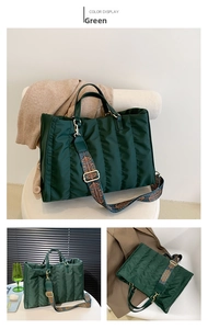 Detail of dark green quilted nylon tote bag with colorful ethnic patterned wide strap