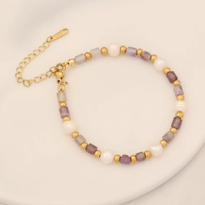 Detailed view of handmade beaded bracelet with purple stones, pearls and S.STEEL clasp
