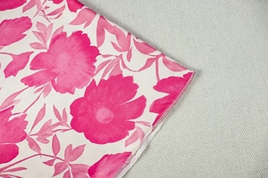 Détail de robe à imprimé floral rose sur tissu tissé blanc cassé avec couture précise