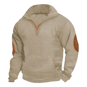 Detail of khaki waffle knit sweatshirt featuring brown faux leather elbow patches