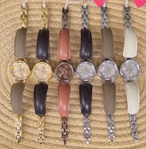 Detail of luxury ladies' watches with rotating flower dials and elegant leather straps
