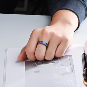 Men's 6mm titanium steel spinner ring with colorful starry sand texture on a hand