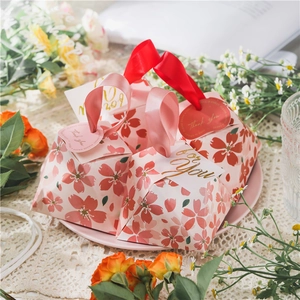 Pink cherry blossom pyramid candy gift boxes with elegant ribbon handles and tags