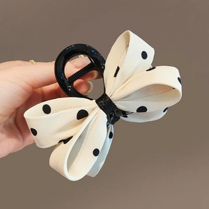 Pince à cheveux avec nœud beige à pois noirs pour un accessoire de coiffure chic