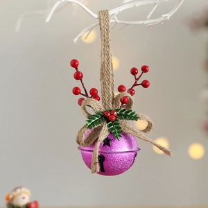 Close-up of purple Christmas bell with red berries and twine loop on a white branch