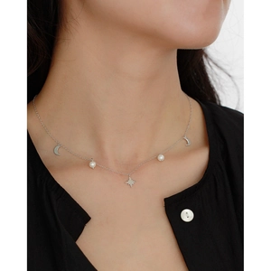 Detail of S925 silver star moon necklace with pearl pendants on a model neck