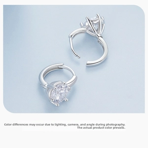 Detail of S925 sterling silver hoop earrings with six-prong set cubic zirconia stones