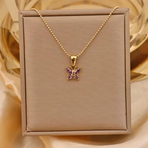 Macro shot of 18K gold plated titanium necklace with purple zircon butterfly pendant