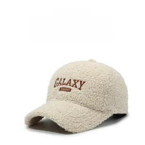 Detailed view of beige teddy fleece baseball cap with Galaxy 1990 letter embroidery