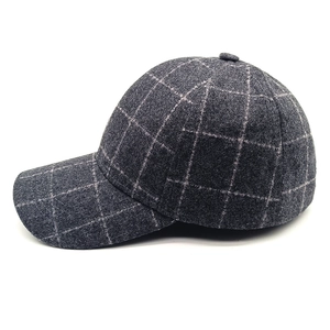 Detail of grey plaid baseball cap with thick wool blend texture and structured brim