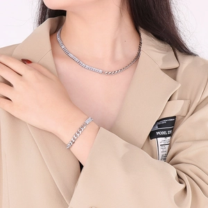 Close-up of silver Cuban link necklace and bracelet set with cubic zirconia stones