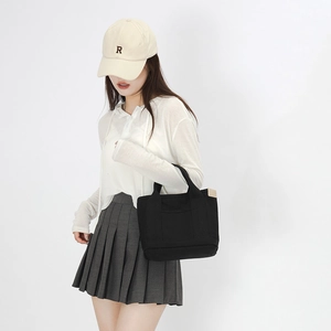Japanese style black canvas tote bag for women shown with casual daily outfit