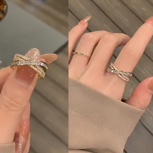 Minimalist gold-plated criss-cross ring set featuring sparkling cubic zirconia stones