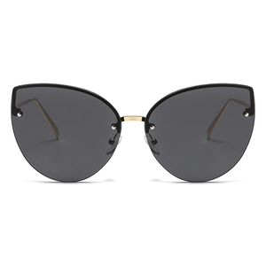 Stylish oversized cat-eye rimless sunglasses with gold metal temples and rivet accents