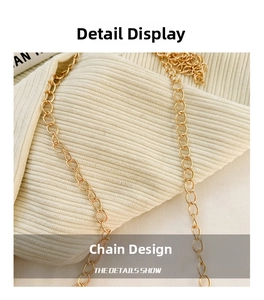 Macro shot of durable gold metal chain strap on a soft beige knitted texture background