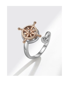 Detailed view of rotating nautical helm ring with Celtic knot and silver open band design