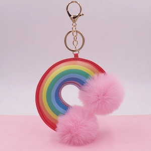 Rainbow leather ring keychain with two large pink plush pom poms and golden metal chain