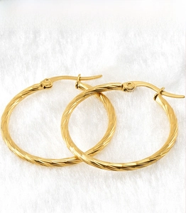 Detail of twisted 18K gold plated stainless steel hoop earrings with secure clasp