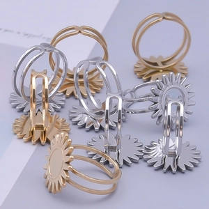 Macro shot of gold and silver stainless steel rings with sunflower design details