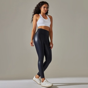 Detail showing the shiny PU leather texture and high waist seam of black leggings