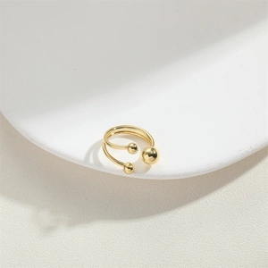 Detail of adjustable gold double layer open ring with polished metal beads ornament