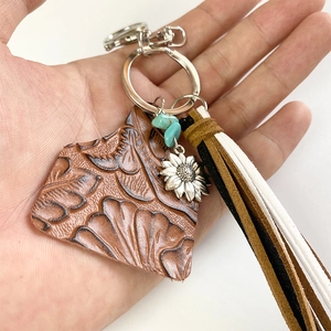 Western boho keychain with brown leather, turquoise sunflower, and suede tassels