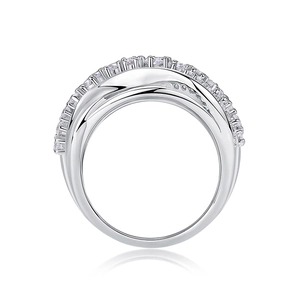 Macro detail of silver layered cross ring with sparkling crystals on white background
