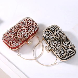 Detailed close-up of luxury red and black clutch bags with diamond vine patterns
