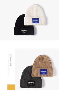Detail view of four ribbed knit beanies with square logo patch in various colors