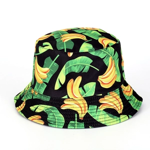 Detailed close-up showing tropical banana and green leaf patterns on black bucket hat fabric