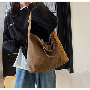 Mirror selfie showing the drape and large capacity of the coffee brown canvas tote bag