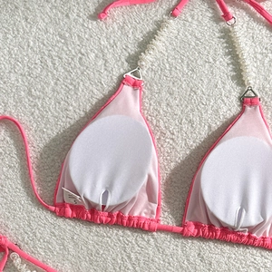 Detail of pink checkerboard bikini top with elegant pearl straps and removable pads