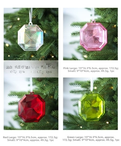 Octagonal faceted gemstone ornaments in various colors hanging on a lighted Christmas tree
