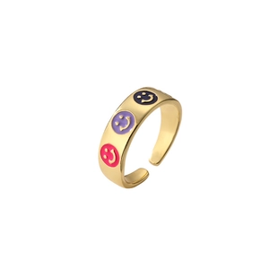 Minimalist gold adjustable ring featuring colorful enamel smiley face motifs on a white background