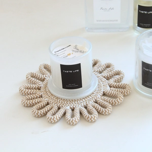 Detail of hand-woven cotton sunflower placemat showing intricate beige rope texture